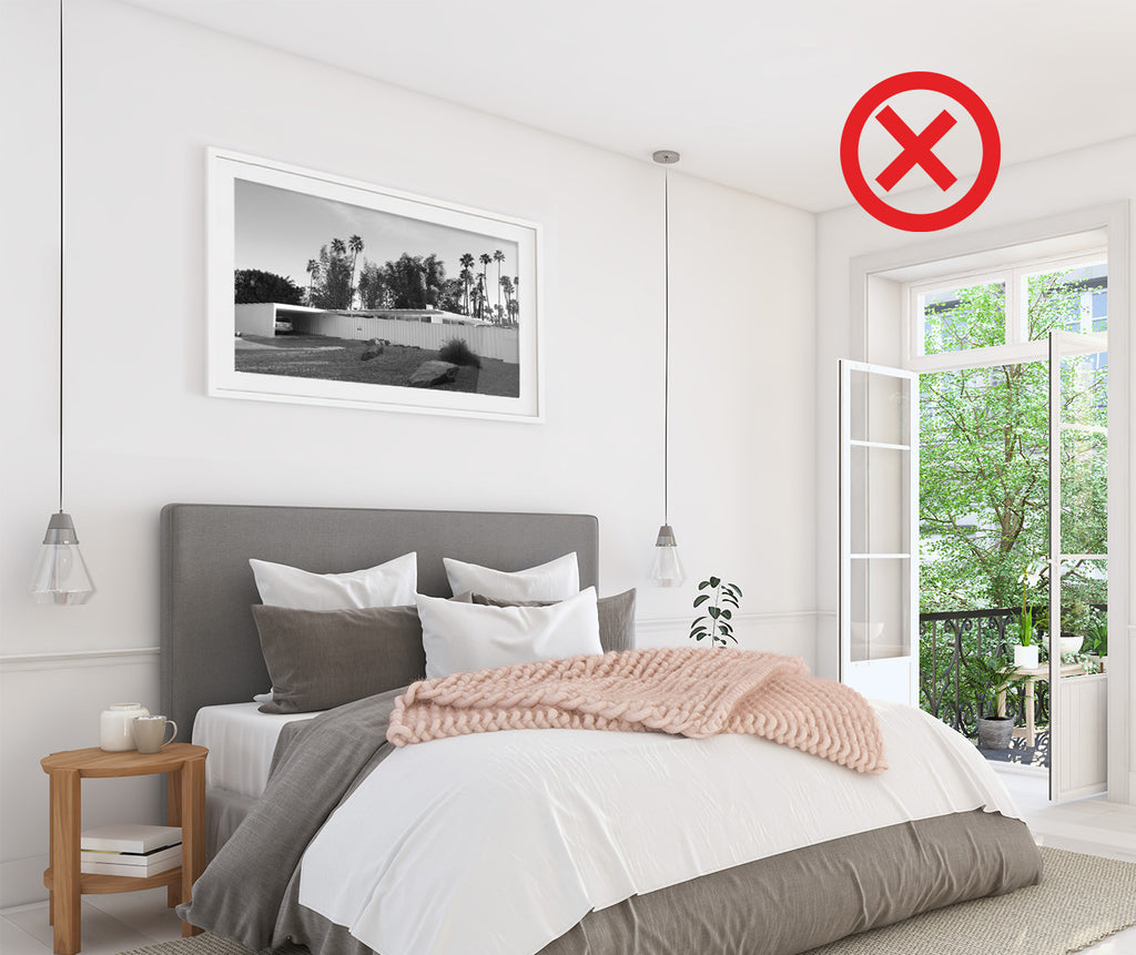 Most common picture hanging mistake in a bedroom
